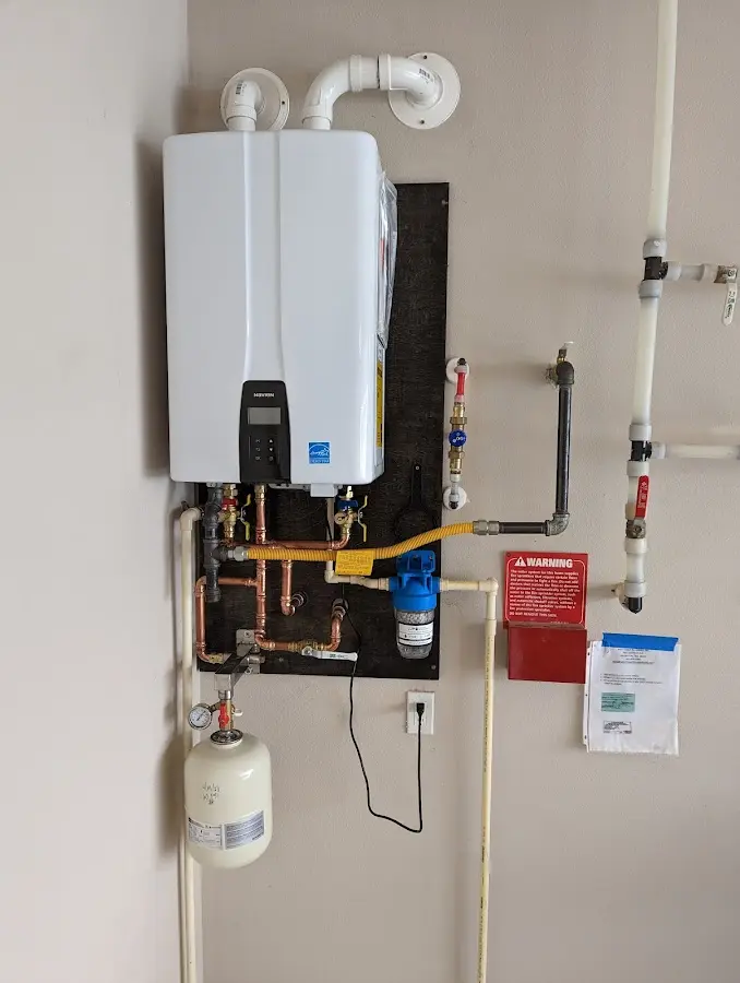 Professional plumber installing copper piping in a Kawkawlin home